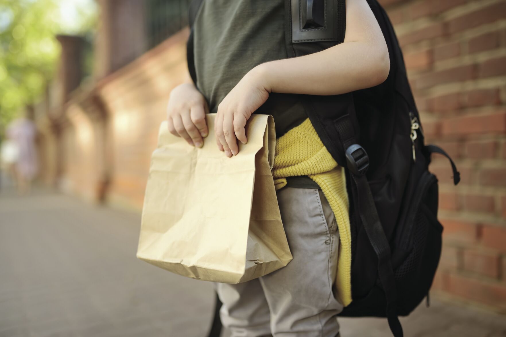 Student with big backpack and lunch bag